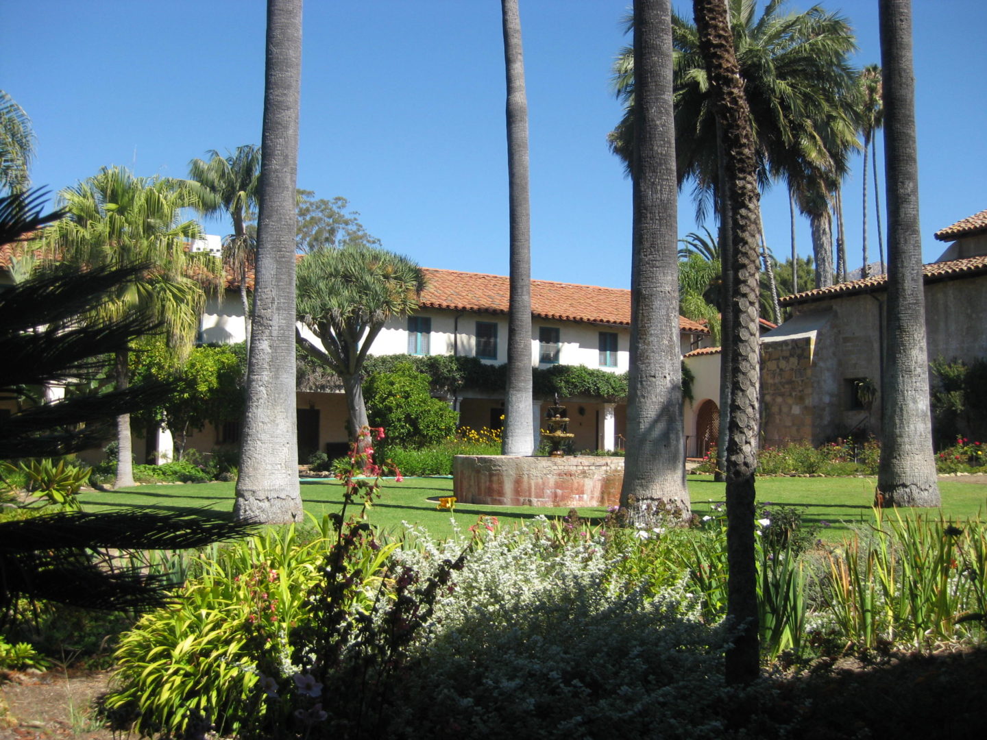 santa barbara mission courtyard with fountain and palm tree view