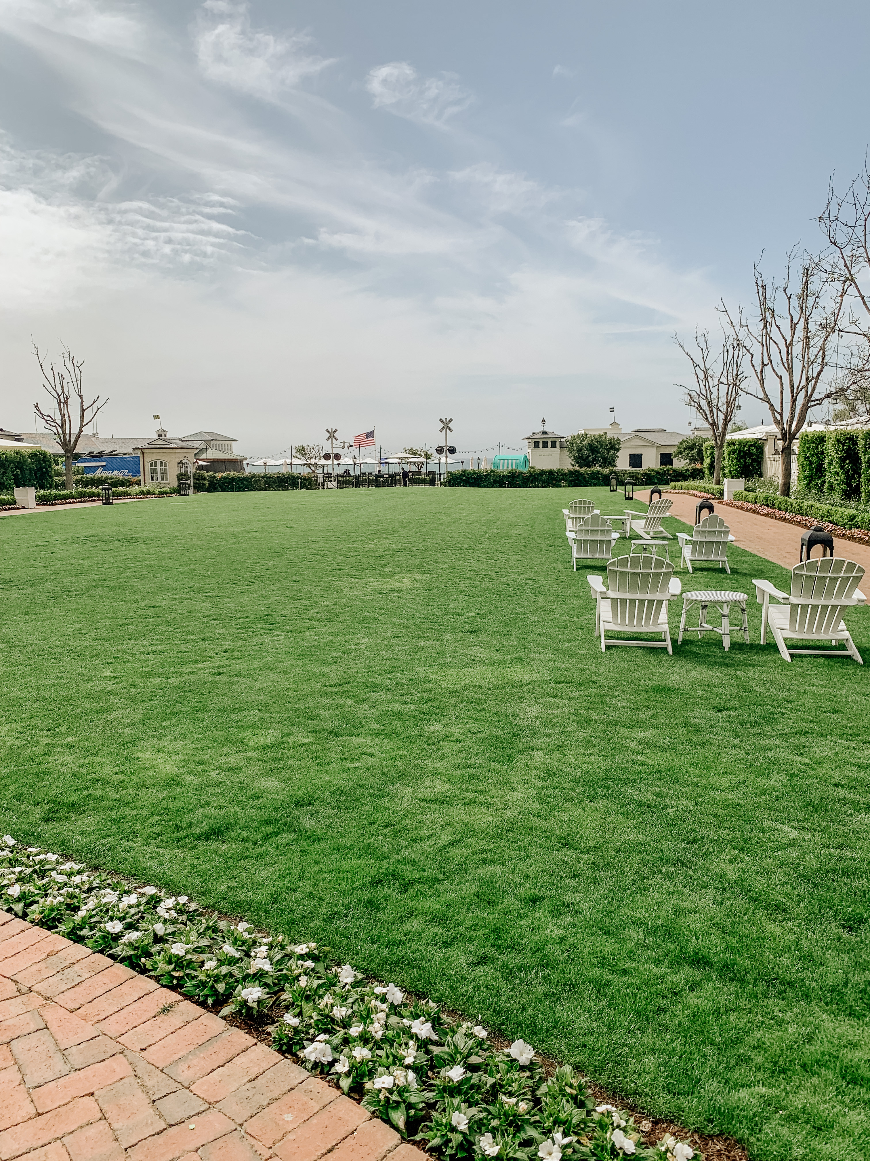 Miramar hotel lawn with Adirondack chairs overlooking the Pacific ocean